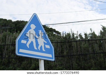blue road sign with  forest