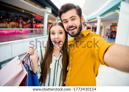 Portrait ogf two people boyfriend girlfriend guy blogger make selfie video call his sweetheart buy purchase hold packages enjoy rejoice trip in shopping mall center
