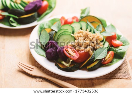 Salad vegetables with quinoa seed on plate and fork ready to eating, Healthy vegan food
