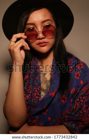 portrait filipino woman using hat and glasses. woman filipino with hat