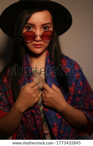 portrait filipino woman using hat and glasses. woman filipino with hat