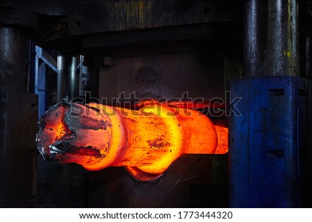 Forging a workpiece on a forging press. Forging production. Royalty-Free Stock Photo #1773444320