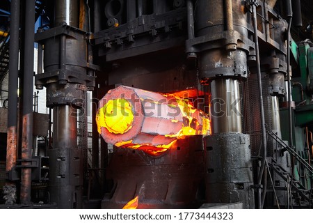Forging a workpiece on a forging press. Forging production. Royalty-Free Stock Photo #1773444323
