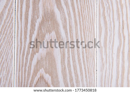 light structure of a white expensive parquet on the floor in the room, closeup photo
