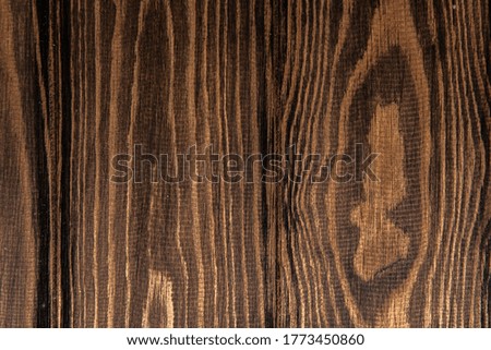 structure of dark brown parquet on the floor in the living room in expensive luxury apartments, close-up photo