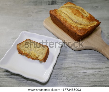 A slice of a warm very moist piece of banana bread with lots of banana and vanilla pudding mix in the batter.