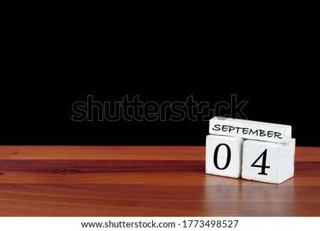 4 September calendar month. 4 days of the month. Reflected calendar on wooden floor with black background