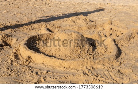 Sand slide on the beach. Sand castle