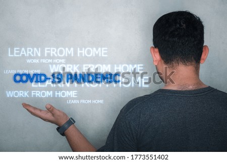 Male open hand with the words of COVID-19 Pandemic surrounded by a relevant word cloud, Work from home and learn from home. Modern abstract background