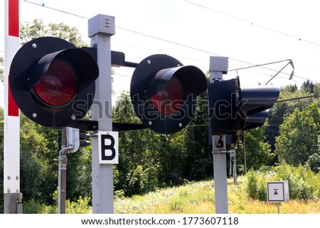 A group of traffic lights at a railway crossing.