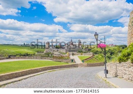 Scenic summer view of ancient fortress castle in Kamianets-Podilskyi, Khmelnytskyi Region, Ukraine. Kamyanets-Podilsky a romantic city on the background of a beautiful sky with clouds 