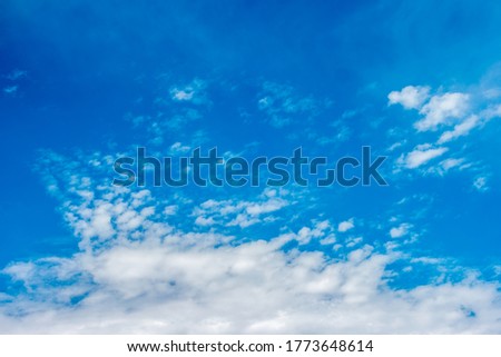 clear blue sky with tiny clouds forming into the larger formations