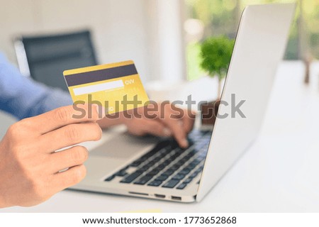 Man hands holding credit card and using laptop. Online shopping