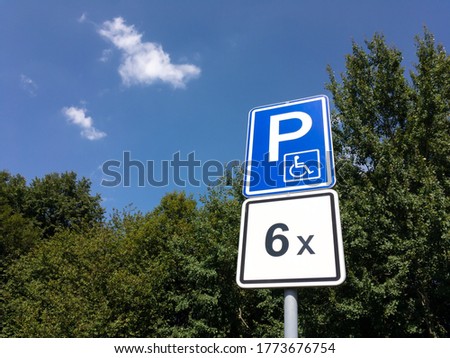 Traffic sign for parking lot which is reserved for cars of disabled people