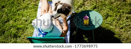 top view of woman and dog sunbathing 