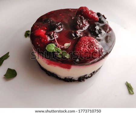 
delicious portion of red fruit cheesecake on white background and photo captured with selective focus