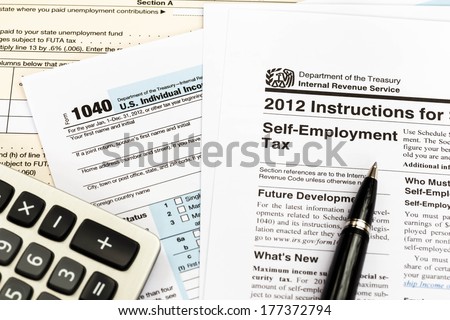 Tax form and instruction with pen, and calculator taxation concept
