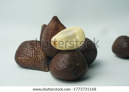 Fresh Zalacca (Salacca zalacca), also known as snake fruit. Isolated on white background