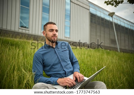 Manager holding laptop, Out of office work, young businessman using computer for his job at outside. Handsome bearded hipster, Communication and technology, in the open air, Surfing