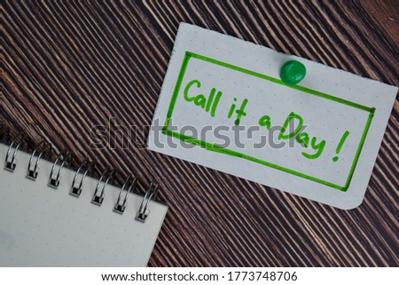 Call it a Day text on sticky notes isolated on office desk.