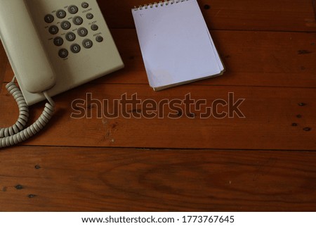 Office desk with notebook, telephone, pen on top view. Business office desk minimal style. Home office concept. work from home