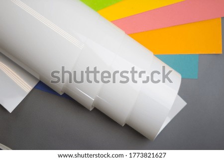 White film for drawing markers, on colored paper backgrounds