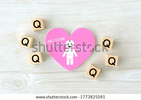 Heart object with baby pictogram and wooden blocks