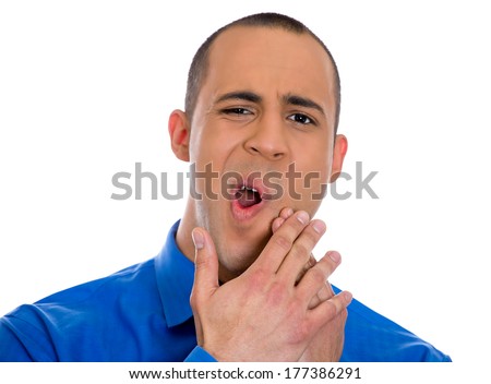 Closeup portrait of young man with sensitive tooth ache crown problem about to cry from pain, touching outside mouth with hand, isolated white background. Negative emotions, facial expression, feeling