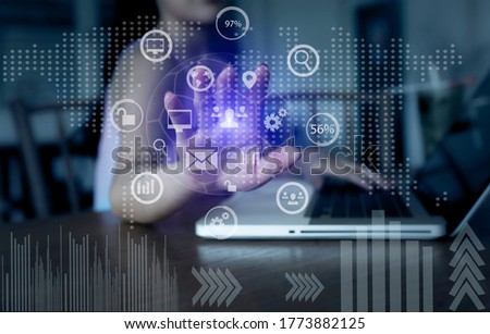 Businesswoman hand using smart business technology virtual interface icons chart, Online marketing concept. Background toned image blurred.