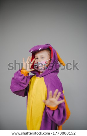 beautiful young girl with nose and mouth mask and dragon costume