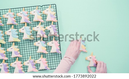 Unicorn sugar cookies decorated with royal icing and food glitter.