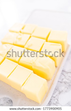 Unsalted butter sticks cut into cubes for preparing Italian buttercream frosting. Royalty-Free Stock Photo #1773900905