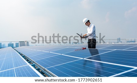 Electrical engineers are using laptops to monitor the operation of the solar rooftop. Renewable energy concepts. Royalty-Free Stock Photo #1773902651