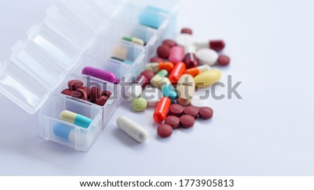 Pill box daily take a medicine, with colorful of pills, tablets, and capsules. Drugs use for treatment and cure the disease. Medication in medical clinic isolated in white background, has copy space. Royalty-Free Stock Photo #1773905813