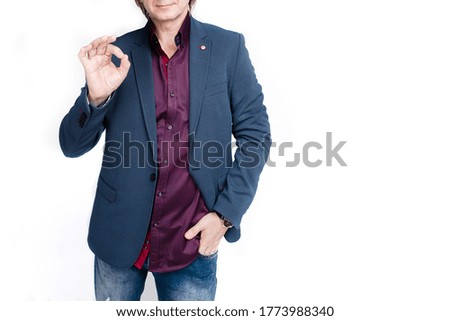 Businessman Showing Ok Sign While Standing Against White Background