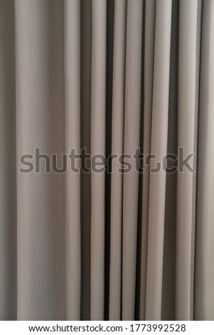 Shades of light grey color of a fabric curtain