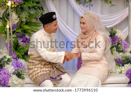 Muslim wedding couple wearing Malay traditional clothing on wedding ceremony.  HAPPY  & FAMILY CONCEPT