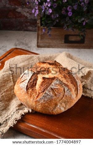 This is a Homemade Sourdough Boule bake by me.  This Boule is a giant round of crusty sourdough and the recipe uses Sourdough starter. It is much like Baguettes. Royalty-Free Stock Photo #1774004897