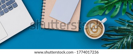 Top view Office desktop with office accessories on blue background banner web Header 