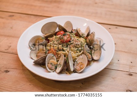 clams over linguine pasta with sauce Royalty-Free Stock Photo #1774035155