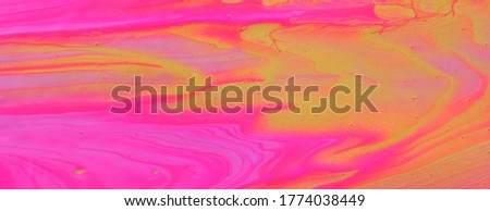 art photography of abstract marbleized effect background. pink and gold creative colors. Beautiful paint.