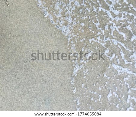 Close up white foam on beach.