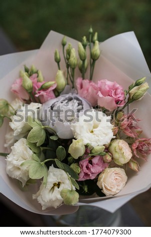 Perfect bouquet of flowers on black table near trees