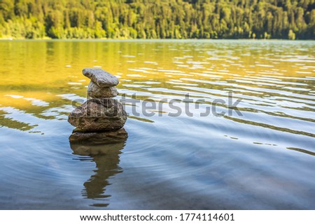 Peaceul landscape image of beautiful Saint Anna lake at summer, focus on the rocks, copy space.