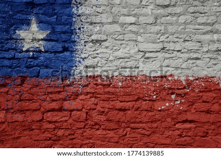 colorful painted big national flag of chile on a massive old brick wall