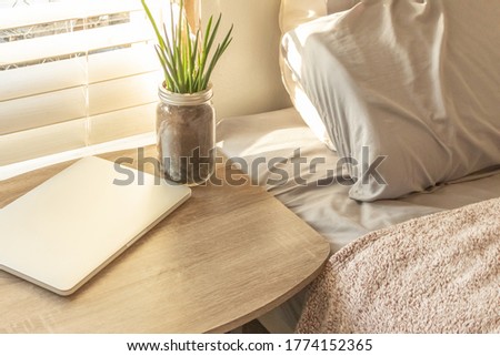 Bed Side Table Top with Laptop and Plant Work from Home Background Royalty-Free Stock Photo #1774152365