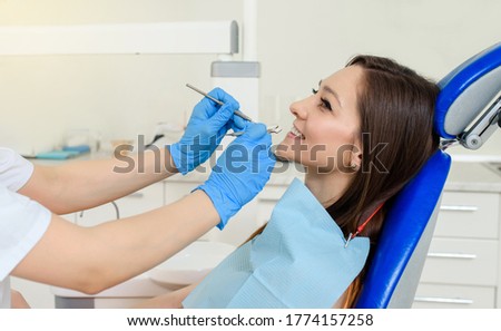 Close up of dentist hands with dental instruments examination patient's teeth in medical clinic