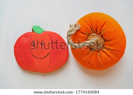 Pumpkin cookie on white wooden background, Halloween sweet and handmade decoration