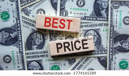 Concept words 'best price' on wooden blocks on a beautiful background from dollar bills. Business concept.