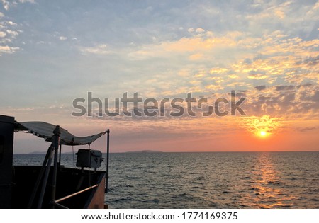 Horizon seascape with bright sun view in the morning with a part of ship navigation bridge on the left of the picture in the Gulf of Thailand, Sattahip district, Chonburi Province, Thailand. 